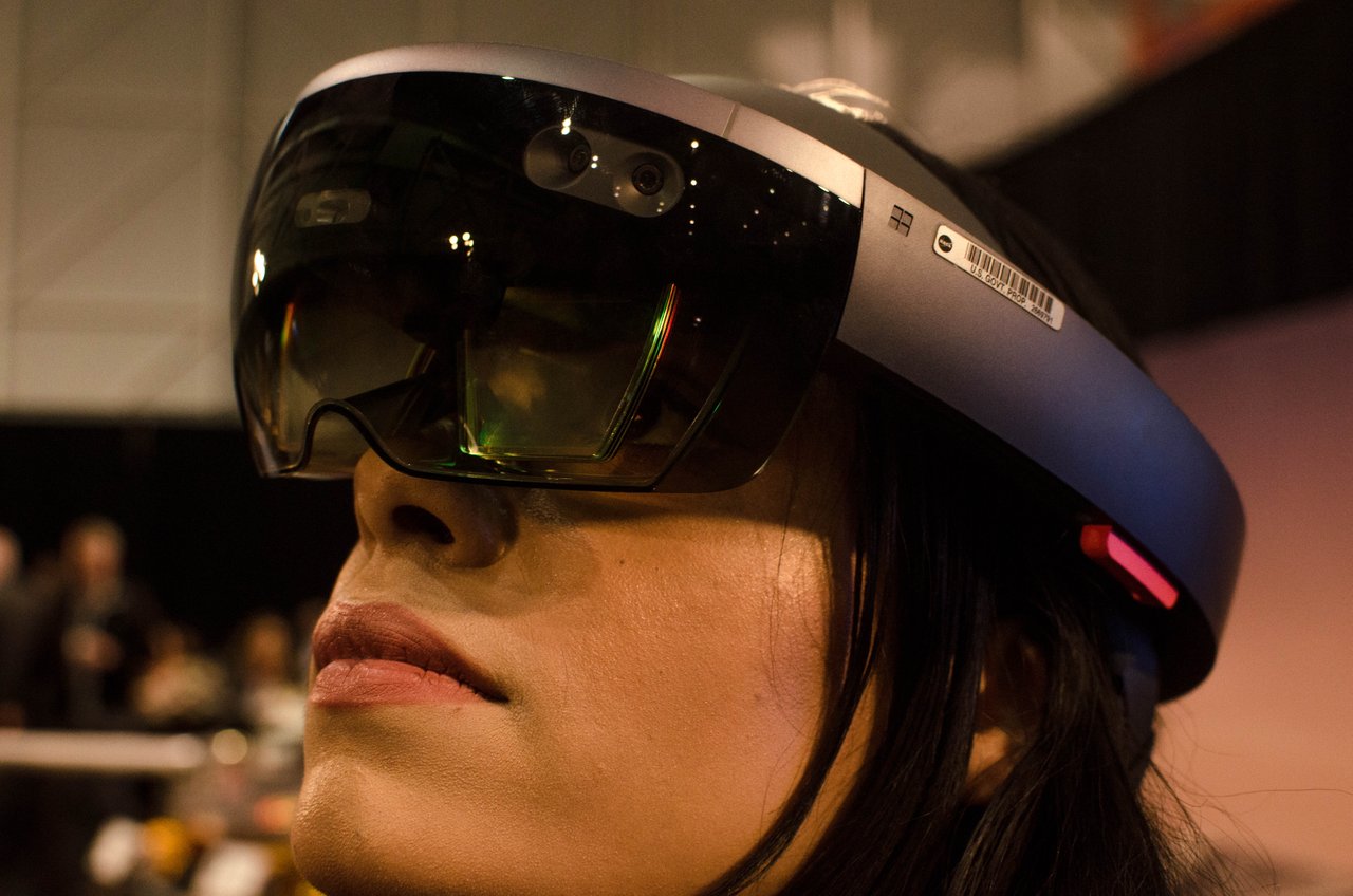 A visitor wearing a HoloLens at the InSight media days, viewing an XR visualization of the mapped surface of Mars