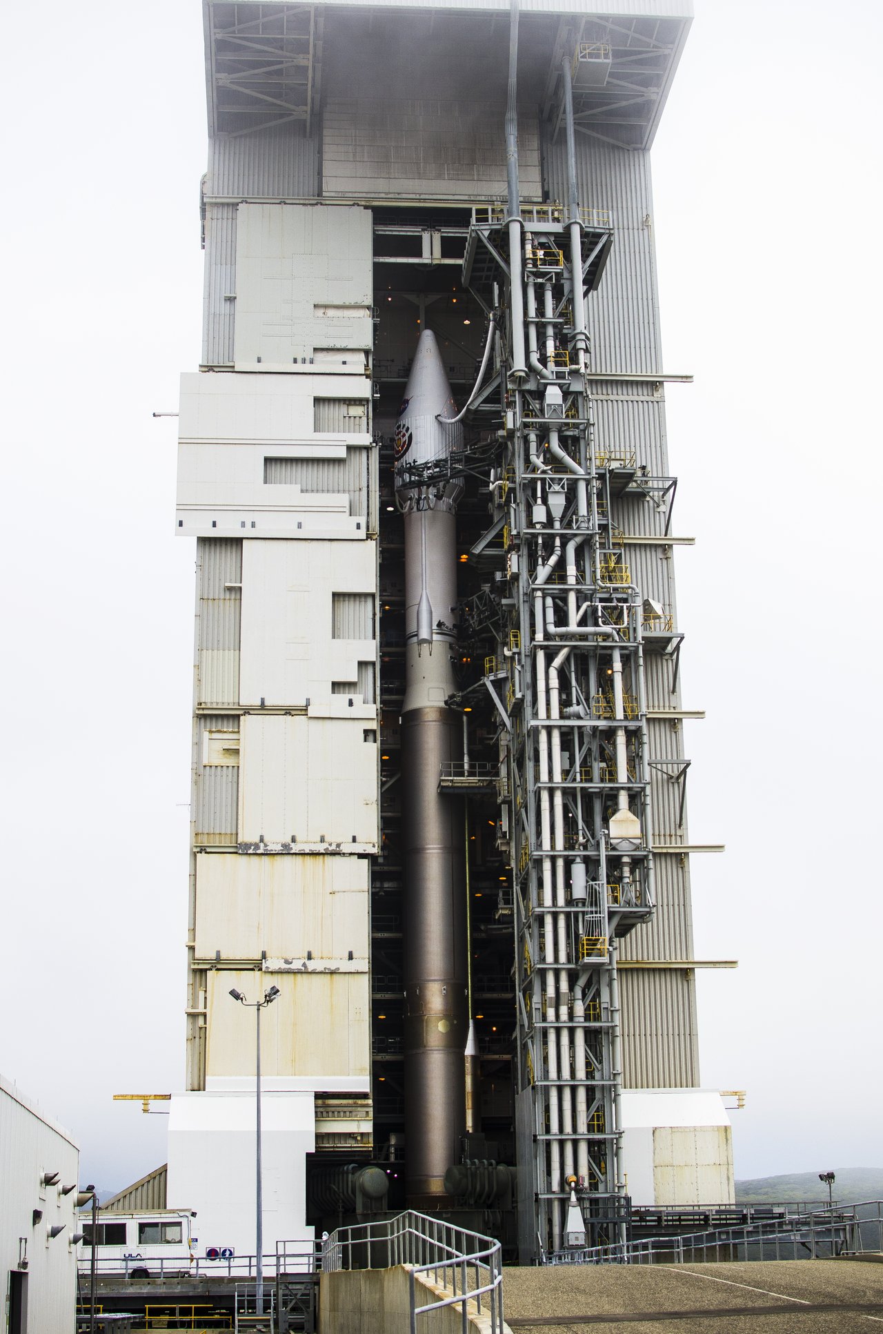The Atlas V 401 rocket with NASA's InSight spacecraft on the pad at Space Launch Complex-3, nearly lost in morning fog